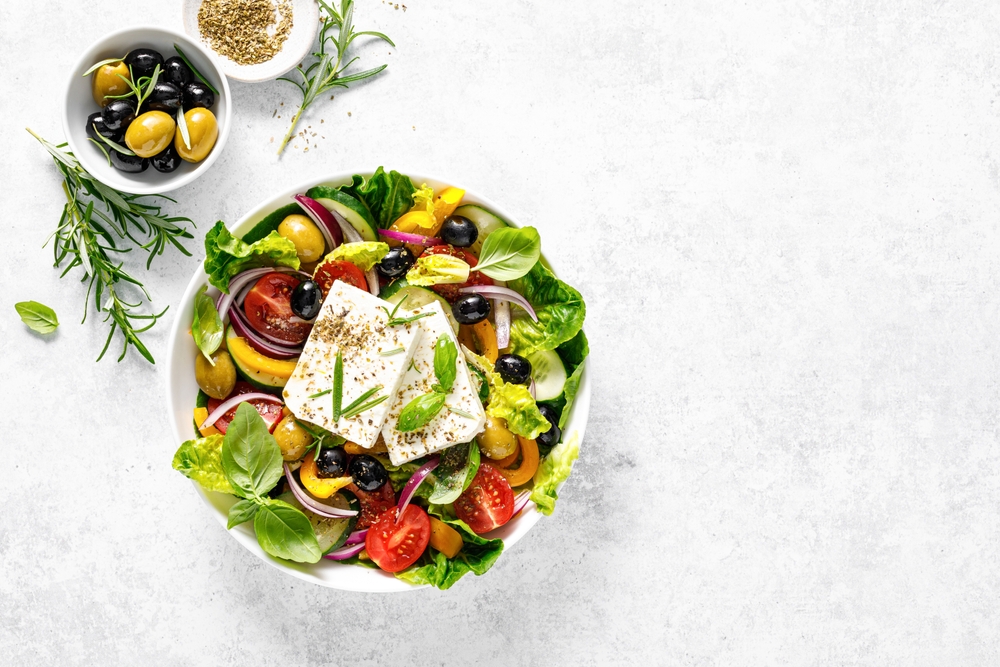 Mediterranean Greek salad with fresh feta cheese, olives, tomatoes, and herbs
